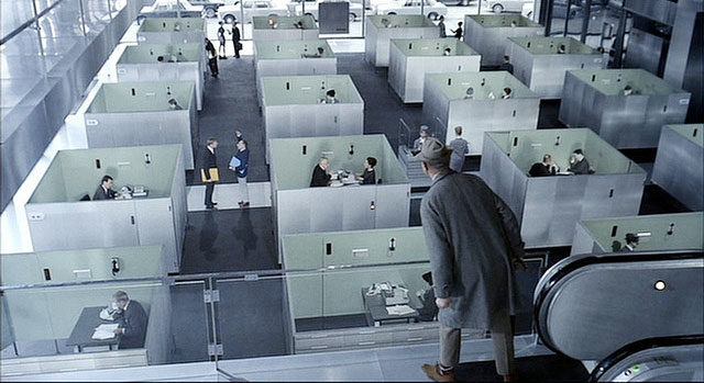 Screenshot from the film Play Time, showing a heavily cubicled office