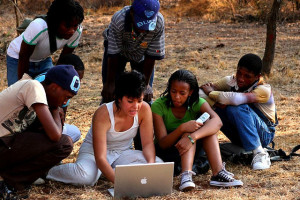 African kids being taught to use a computer